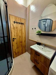a bathroom with a sink and a wooden door at Amore in Vir +13 photos