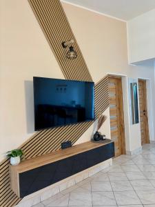 a living room with a large flat screen tv on a wall at Amore in Vir