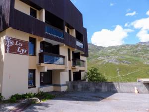 a building with a sign on the side of it at travelski home select - Résidence Les Lys in Les Menuires