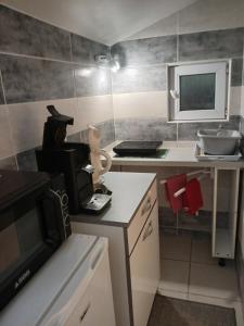 a small kitchen with a stove and a microwave at Le lys in Saintes