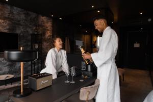 a man and a woman standing at a bar with a bottle of wine at Van der Valk Hotel Amsterdam - Amstel in Amsterdam +56 photos
