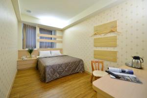 Postel nebo postele na pokoji v ubytování Ing Wang Hotel