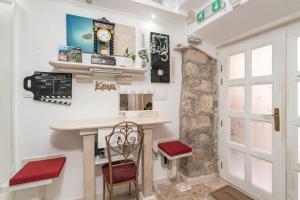 a home office with a desk and a clock on the wall at Mia Casa Dubrovnik in Dubrovnik