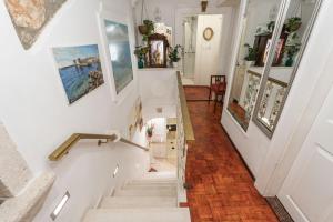 a staircase in a home with art on the walls at Mia Casa Dubrovnik in Dubrovnik +52 photos