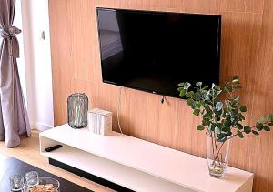 a living room with a tv on a wall at Lumina OVO2 in Wrocław