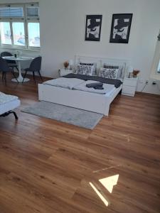 a bedroom with a bed and a wooden floor at Apartman MWM Brno 2 in Brno