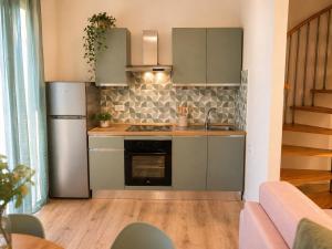 a kitchen with a refrigerator and a stove at I Bimbi - Suite Apartment in Livorno