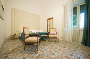 a dining room with a table and two chairs at BIANCA ROOMS in Noto