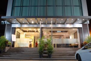 a building with stairs and plants in front of it at Hotel Silver Seven in Jāmb