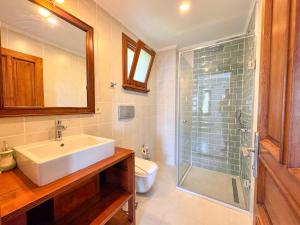 a bathroom with a sink and a glass shower at Villa Noa Amazing Sea view in Kaş +28 photos