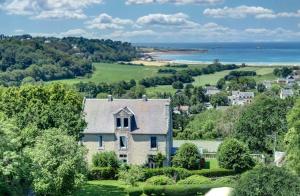 an aerial view of a house with the ocean in the background at BellevueBretagne - Chambres d'Hôtes in Saint-Jean-du-Doigt