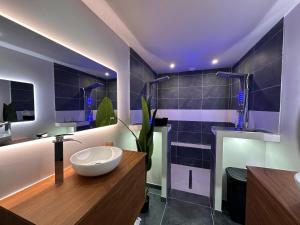 a bathroom with a sink and a large bowl at L'Envol - Jacuzzi, Sauna et belle vue in Cherbourg en Cotentin +21 photos