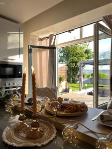 a kitchen counter with a table with food and candles at L'Envol - Jacuzzi, Sauna et belle vue in Cherbourg en Cotentin