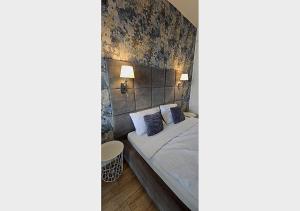 a bedroom with a bed with a brick wall at Lumina OVO2 in Wrocław +31 photos