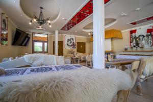 a bedroom with a large white bed with white blankets at Residence Spa Harenda in Zakopane