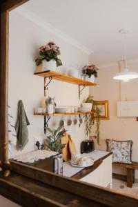 a kitchen with a counter with flowers on the wall at The Hidden Garden Guesthouse in Meyerton +25 photos