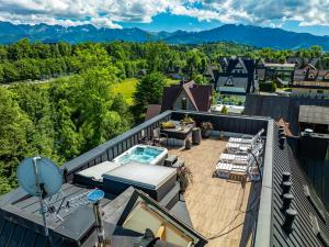 an outdoor deck with a view of the mountains at Residence Spa Harenda in Zakopane