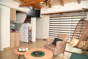 a living room with a table and a chair at Kutak u Vranicu in Vranic +20 photos