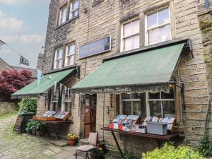 a book store with a green awning on a brick building at Underview in Holmfirth