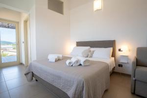 a bedroom with a bed with towels on it at Bagno Lunezia in Marina di Carrara