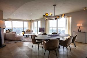 a living room with a dining table and chairs at O'Ciel 24 - Exceptional 24th floor Residence - Ostend in Ostend