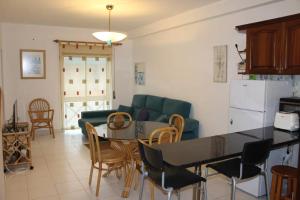 a kitchen and living room with a table and a couch at Sweet West in Lourinhã