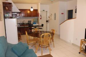 a kitchen and dining room with a table and chairs at Sweet West in Lourinhã +4 photos