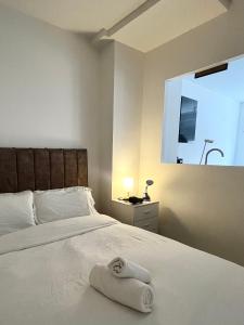 a bedroom with a bed with a white towel on it at Digbeth Luxury 1 Bed Studio Apartment in Birmingham