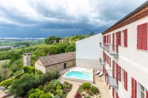 an aerial view of a building with a swimming pool at OLIVOLA APARTMENTS in Frassinello