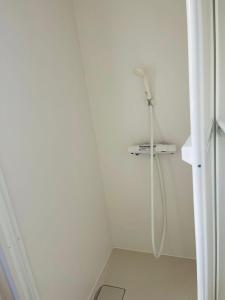 a white bathroom with a shower in a room at Nono in Takamatsu +46 photos