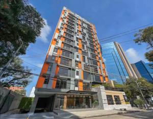 a tall building with an orange at EON Two Bedroom Apartment 1303 in Estación Pamplona