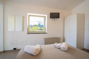 a bedroom with a bed with two towels on it at Bagno Lunezia in Marina di Carrara