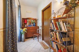 a room with a book shelf filled with books at Terraluna in Monforte dʼAlba