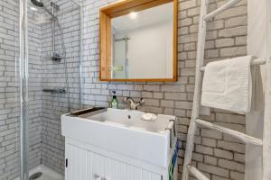 a white bathroom with a sink and a mirror at Casa Do Canto in Cascais +15 photos