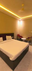 a bedroom with a bed and chairs in a room at hotel grand vk #Ac family rooms#free wifi#free parking in Agra