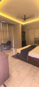 a bedroom with two beds and a table and chairs at hotel grand vk #Ac family rooms#free wifi#free parking in Agra