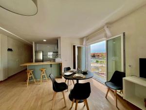 a living room with a table and chairs and a large window at Vera Naked in Vera