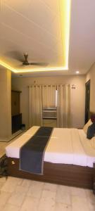 a bedroom with two beds in a room at hotel grand vk #Ac family rooms#free wifi#free parking in Agra +7 photos