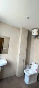 a bathroom with a toilet and a sink at hotel grand vk #Ac family rooms#free wifi#free parking in Agra