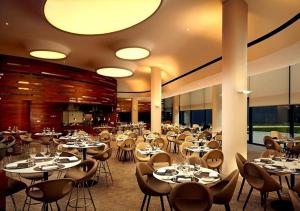a dining room with tables and chairs in a building at Lumina OVO2 in Wrocław