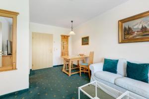 a living room with a couch and a table at Apartment mit Gartenblick K1 206 in Spalt
