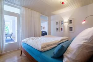 a bedroom with a bed and a window with a chair at Alm-Atelier in Durbach