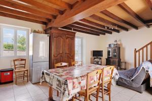 a kitchen with a table and a refrigerator at Gîte La Chapelière in Assay