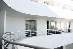 a spiral staircase in a building with windows at Lumina OVO2 in Wrocław