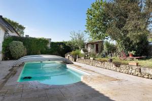 a swimming pool in a yard next to a house at Gite À La Tite Boulite in Vouneuil-sous-Biard