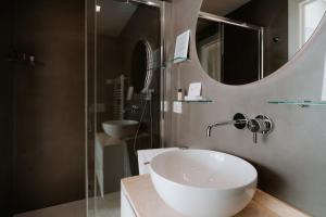 a bathroom with a sink and a mirror at Locanda da Toto in Genoa +62 photos
