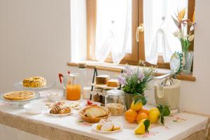 a table topped with breakfast foods and orange juice at Villa Le Murelle in Tramonti