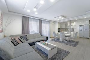 a living room with a couch and a table at Holiday Villa Pervan in Sesvete