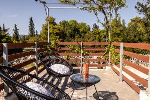 a patio with two chairs and a table at Green Oak Villa in Orthoniaí +38 photos