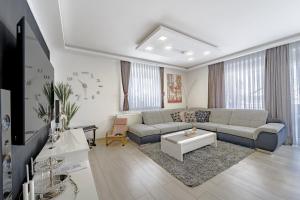 a living room with a couch and a table at Holiday Villa Pervan in Sesvete